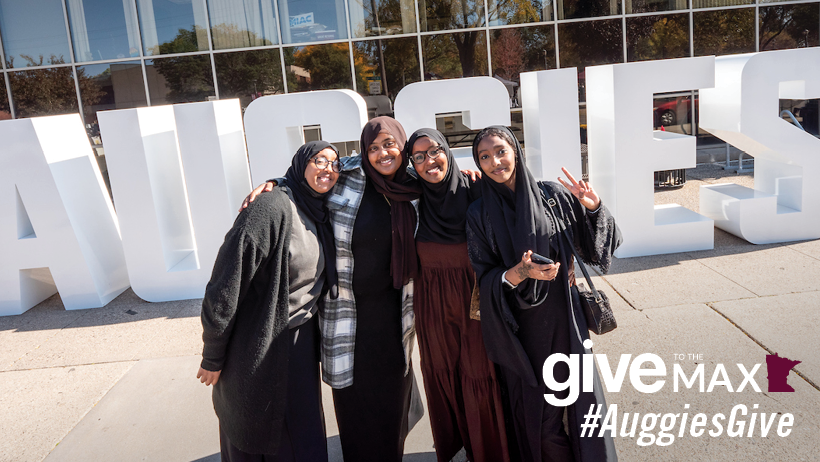 Students standing in front of Auggies sign.